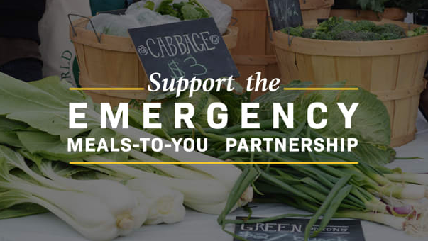 table with healthy greens text support the emergency meals to you partnership